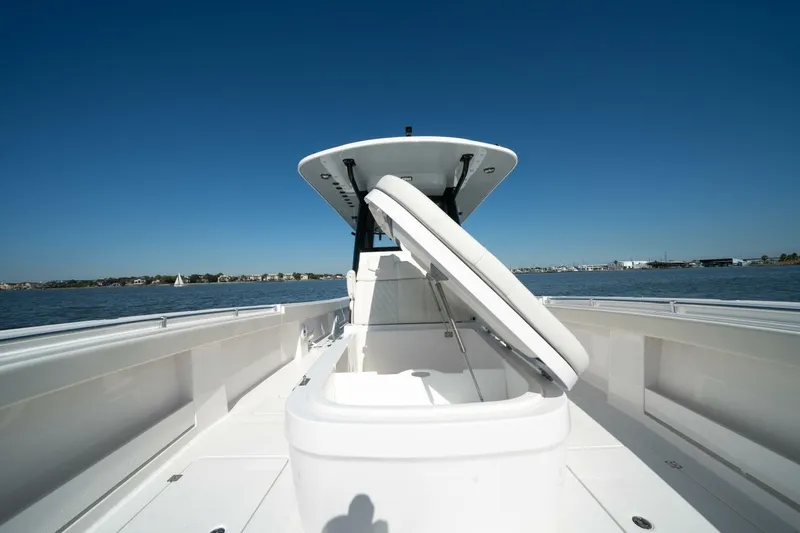  Yacht Photos Pics 2021 Invincible 35 Catamaran on water, open storage compartment, clear blue sky.