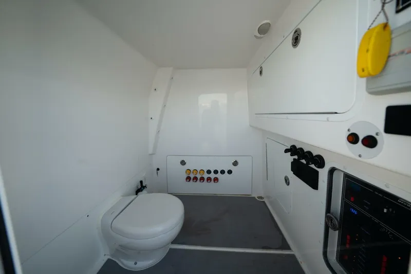  Yacht Photos Pics Interior of 2021 Invincible 35 Catamaran featuring a compact marine bathroom setup.