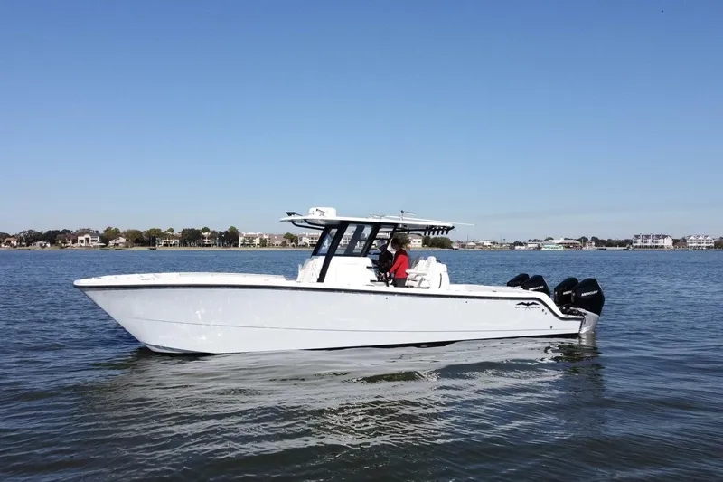  Yacht Photos Pics 2021 Invincible 35 Catamaran on calm water, showcasing sleek design and powerful engines.