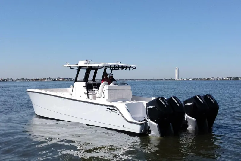  Yacht Photos Pics 2021 Invincible 35 Catamaran with triple Mercury engines cruising on open water.