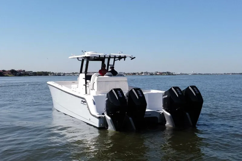  Yacht Photos Pics 2021 Invincible 35 Catamaran with quad engines cruising on calm waters.
