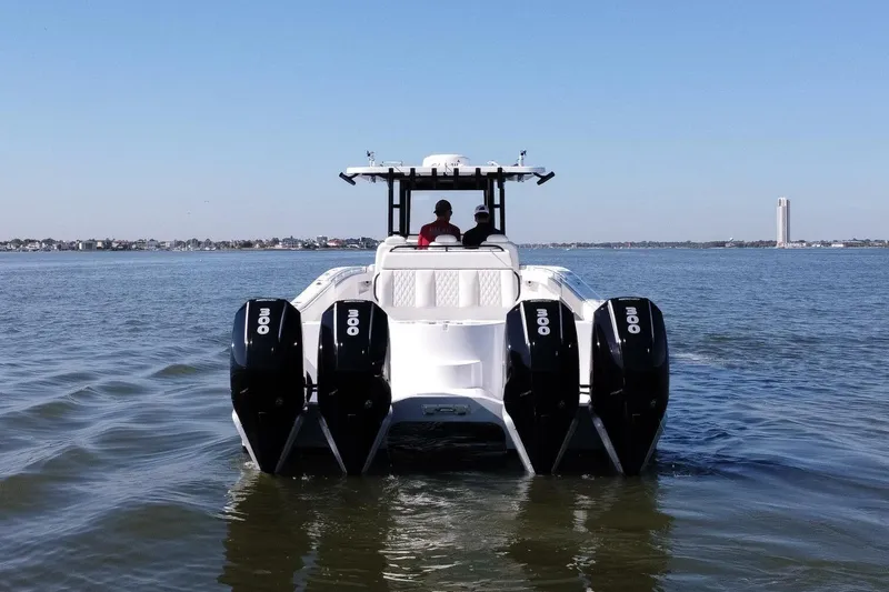  Yacht Photos Pics 2021 Invincible 35 Catamaran with quad engines cruising on open water.