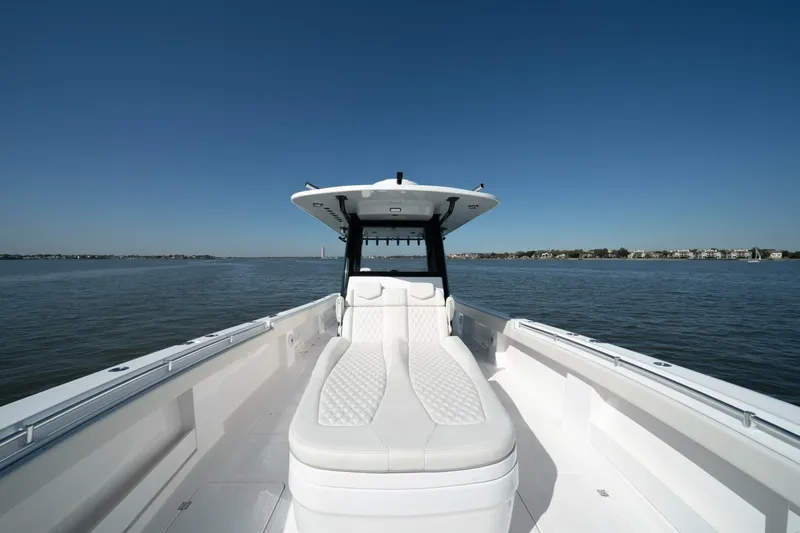  Yacht Photos Pics 2021 Invincible 35 Catamaran on calm water, showcasing sleek design and spacious deck.