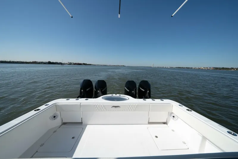  Yacht Photos Pics 2021 Invincible 35 Catamaran on open water, showcasing spacious deck and triple engines.