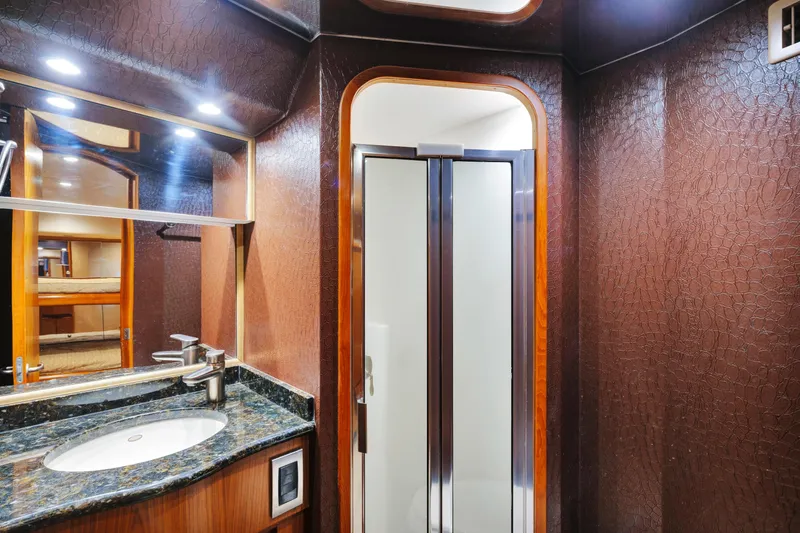 Cutter Bill Yacht Photos Pics Luxurious bathroom in 2011 Viking 70 Convertible yacht with elegant wood and granite finishes.
