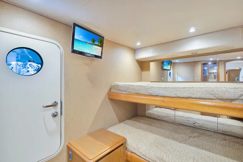 Cutter Bill Yacht Photos Pics Interior of 2011 Viking 70 Convertible yacht with cozy bunk beds and TV.