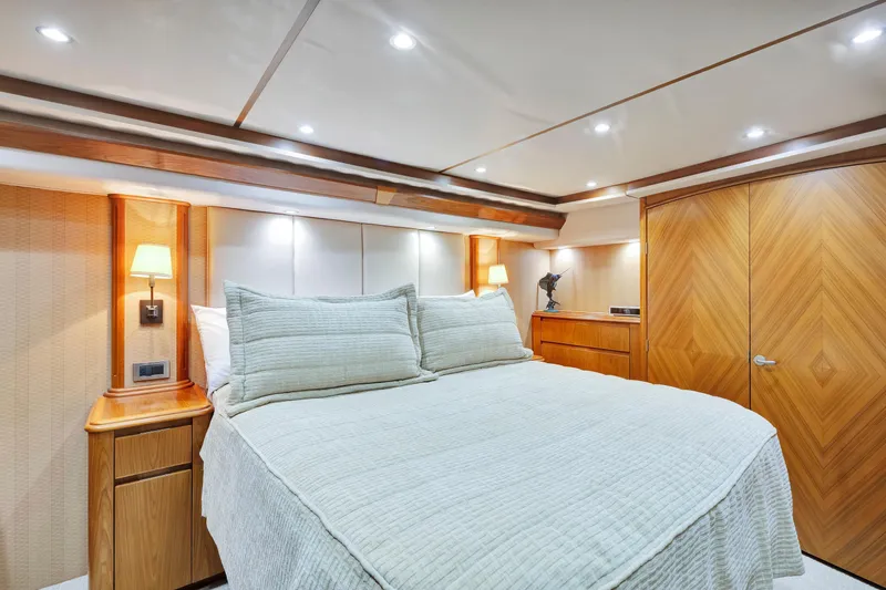 Cutter Bill Yacht Photos Pics Luxurious bedroom interior of 2011 Viking 70 Convertible yacht with elegant wood finishes.