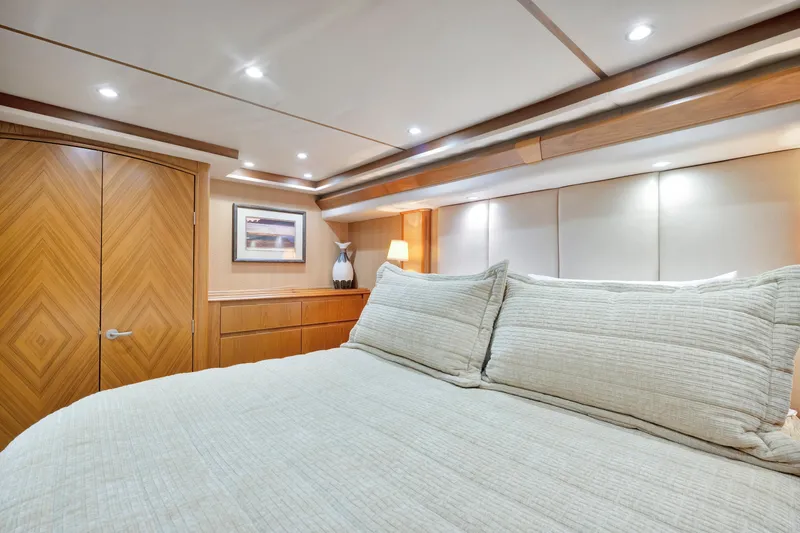 Cutter Bill Yacht Photos Pics Luxurious bedroom interior of 2011 Viking 70 Convertible yacht with elegant wood finishes.