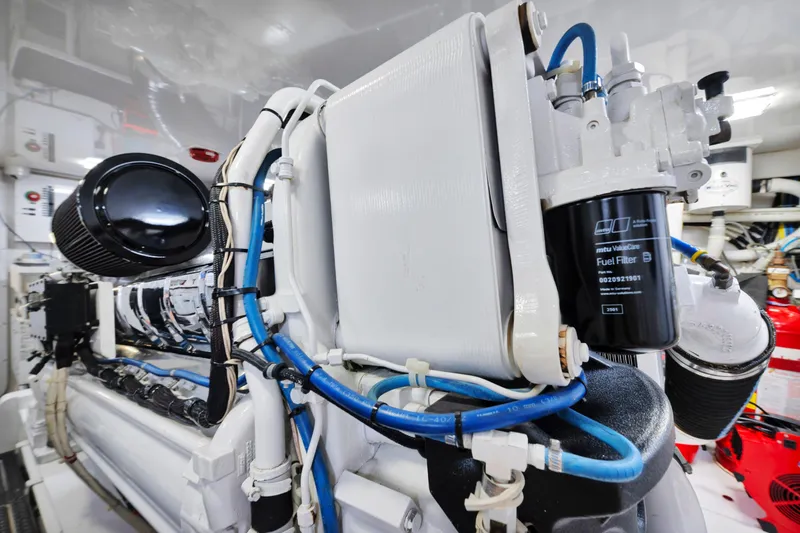 Cutter Bill Yacht Photos Pics Engine room of 2011 Viking 70 Convertible yacht, showcasing fuel filter and intricate piping.