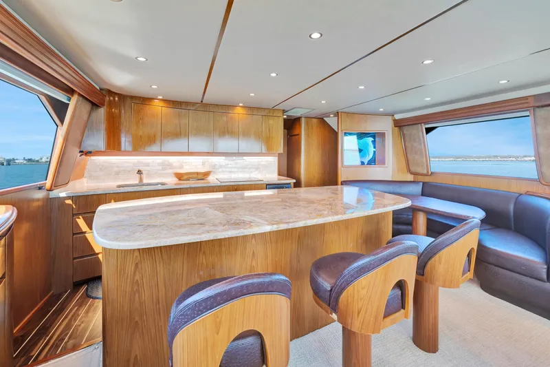 Cutter Bill Yacht Photos Pics Luxurious interior of 2011 Viking 70 Convertible yacht with elegant wood finishes and ocean view.