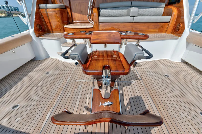 Cutter Bill Yacht Photos Pics Luxury teak deck of 2011 Viking 70 Convertible yacht with elegant seating and fishing chair.