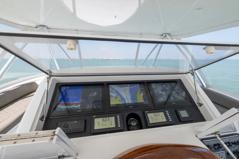 Cutter Bill Yacht Photos Pics Cockpit view of 2011 Viking 70 Convertible yacht with navigation screens and ocean backdrop.