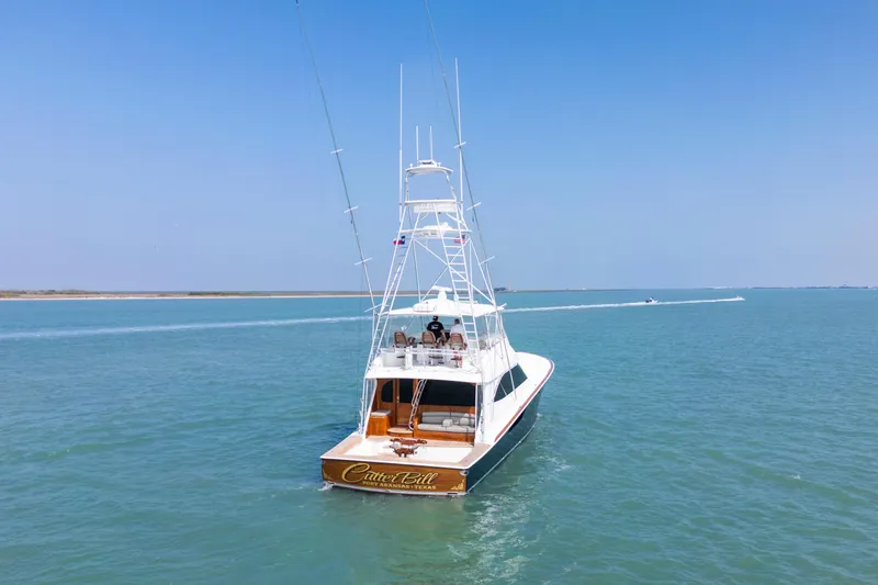 Cutter Bill Yacht Photos Pics 2011 Viking 70 Convertible yacht cruising on open water under clear blue skies.