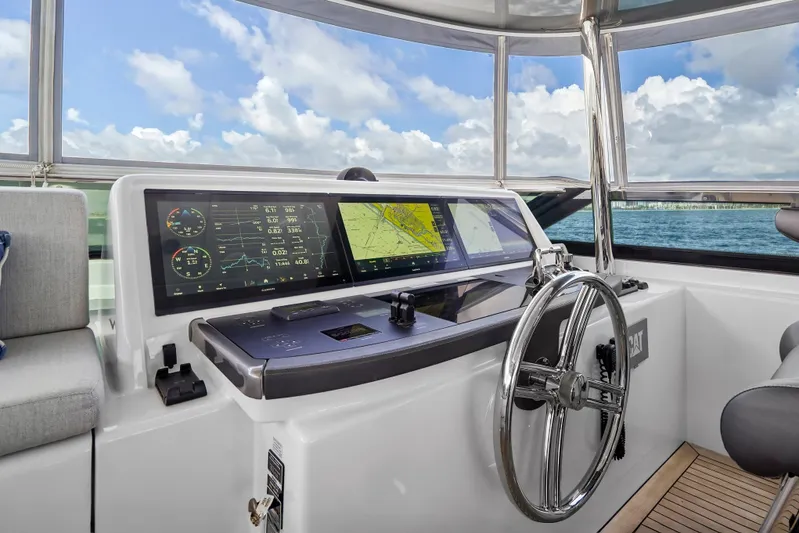 Surplus Lines Yacht Photos Pics Helm of 2019 Hatteras M90 Panacera yacht with navigation screens and steering wheel.