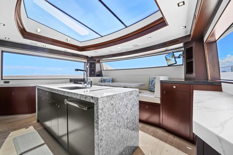 Surplus Lines Yacht Photos Pics Luxurious interior of 2019 Hatteras M90 Panacera yacht with skylight and modern kitchen.