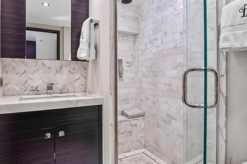 Surplus Lines Yacht Photos Pics Luxurious bathroom in 2019 Hatteras M90 Panacera yacht with marble shower and modern vanity.