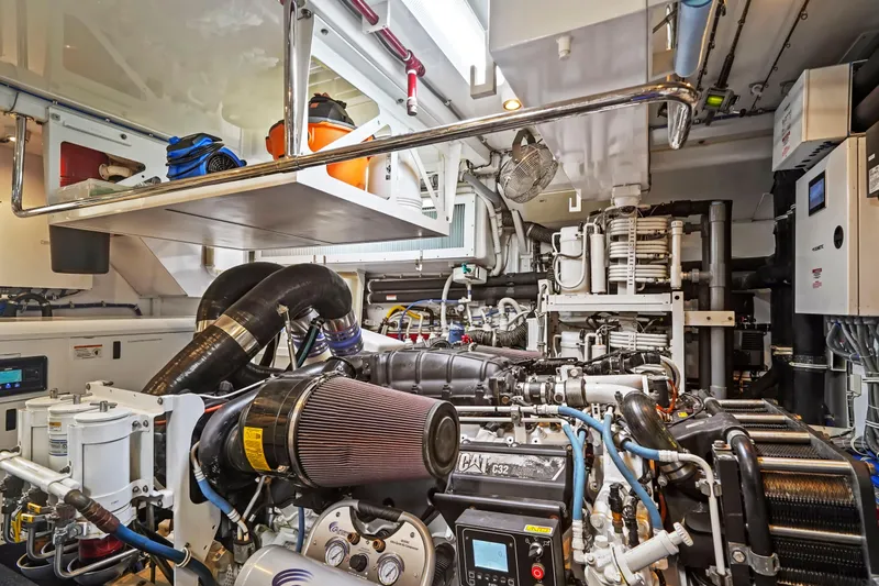 Surplus Lines Yacht Photos Pics Engine room of 2019 Hatteras M90 Panacera yacht, showcasing complex machinery and equipment.