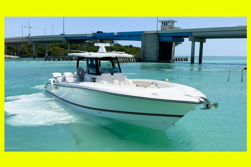 Aquamarine Yacht Photos Pics 2019 HCB 39 Speciale boat cruising in turquoise waters near a bridge.