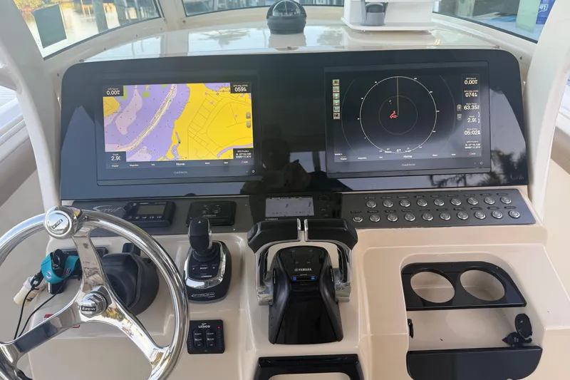  Yacht Photos Pics 2016 Scout 300 LXF boat dashboard with Garmin navigation displays and controls.