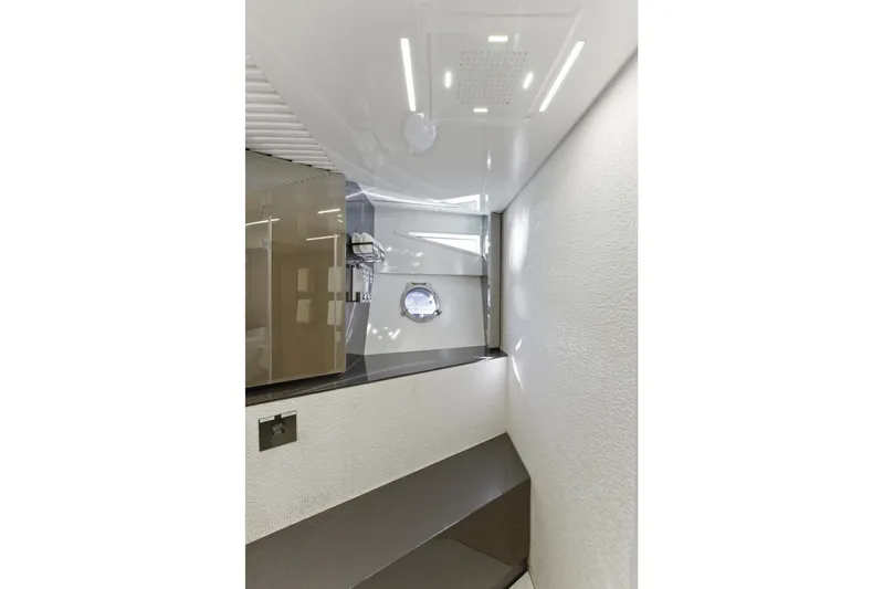 Date Night Yacht Photos Pics Luxurious bathroom interior of 2018 Ferretti Yachts 920 with modern fixtures and porthole window.