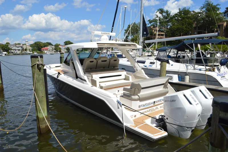 Station Break Yacht Photos Pics 2024 Tiara Yachts 34 LS docked, featuring dual Mercury engines, in a scenic marina setting.