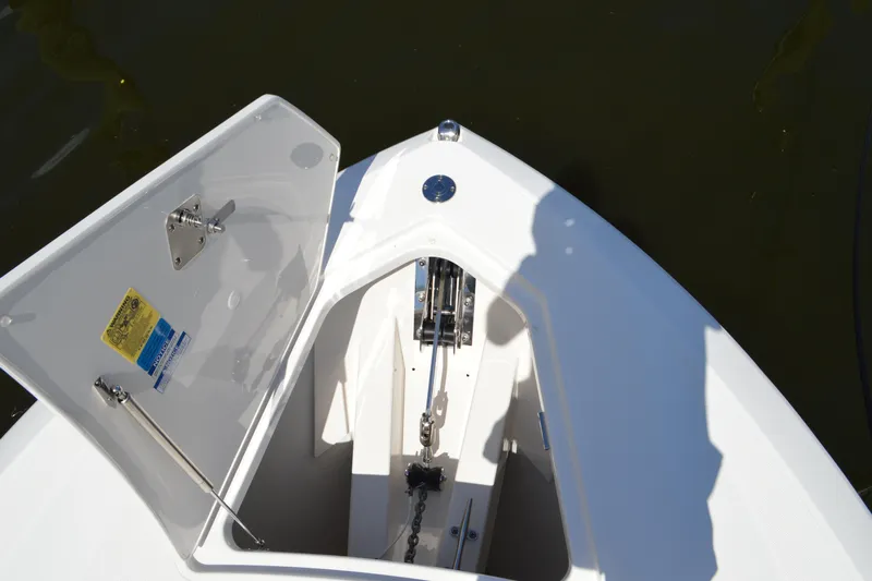 Station Break Yacht Photos Pics 2024 Tiara Yachts 34 LS anchor locker with open hatch, showcasing chain and mechanism.