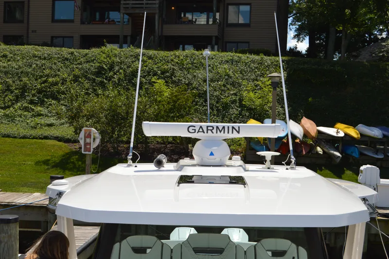 Station Break Yacht Photos Pics 2024 Tiara Yachts 34 LS with Garmin radar, docked near kayaks and greenery.