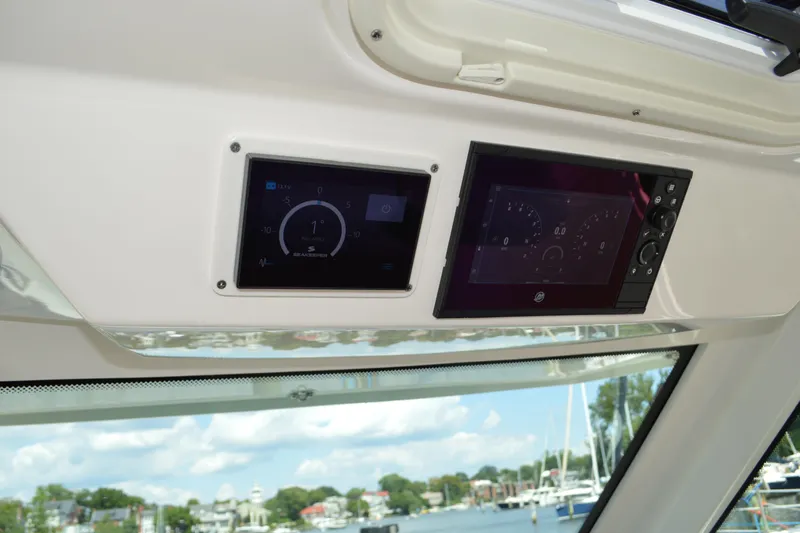 Station Break Yacht Photos Pics 2024 Tiara Yachts 34 LS dashboard with digital displays and scenic marina view.