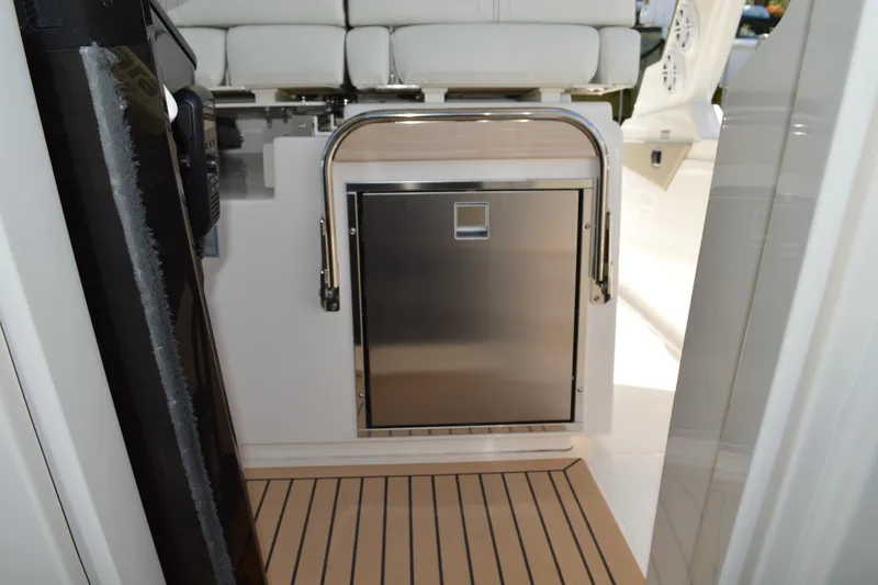 Station Break Yacht Photos Pics 2024 Tiara Yachts 34 LS interior with stainless steel appliance and cushioned seating.