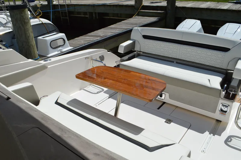 Station Break Yacht Photos Pics 2024 Tiara Yachts 34 LS interior with elegant seating and wooden table.