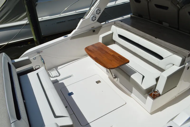 Station Break Yacht Photos Pics 2024 Tiara Yachts 34 LS interior with sleek seating and wooden table.