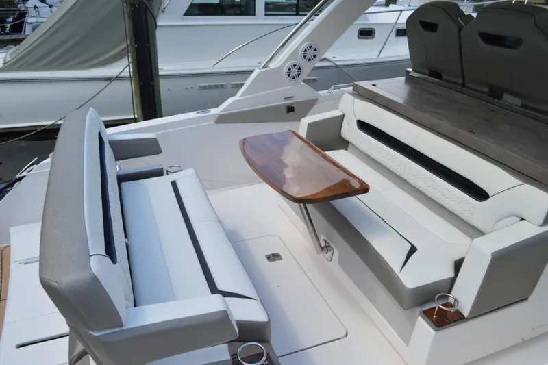 Station Break Yacht Photos Pics 2024 Tiara Yachts 34 LS interior with elegant seating and wooden table.