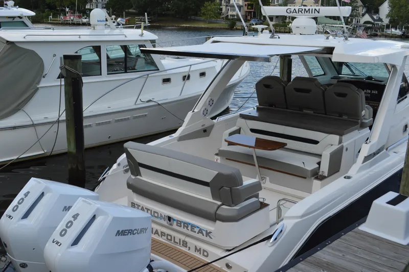 Station Break Yacht Photos Pics 2024 Tiara Yachts 34 LS docked, featuring spacious seating and dual Mercury engines.
