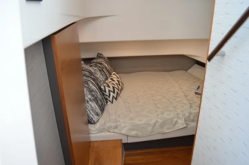 Station Break Yacht Photos Pics Cozy cabin interior of 2024 Tiara Yachts 34 LS with stylish bedding and pillows.