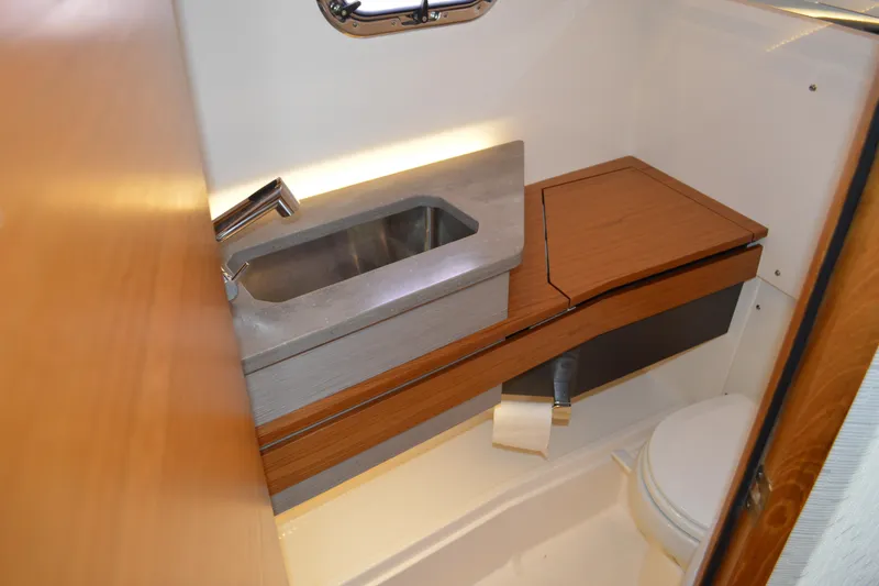 Station Break Yacht Photos Pics 2024 Tiara Yachts 34 LS bathroom with modern sink and wooden accents.