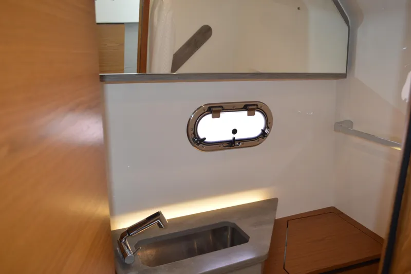 Station Break Yacht Photos Pics 2024 Tiara Yachts 34 LS interior with sink and porthole window.