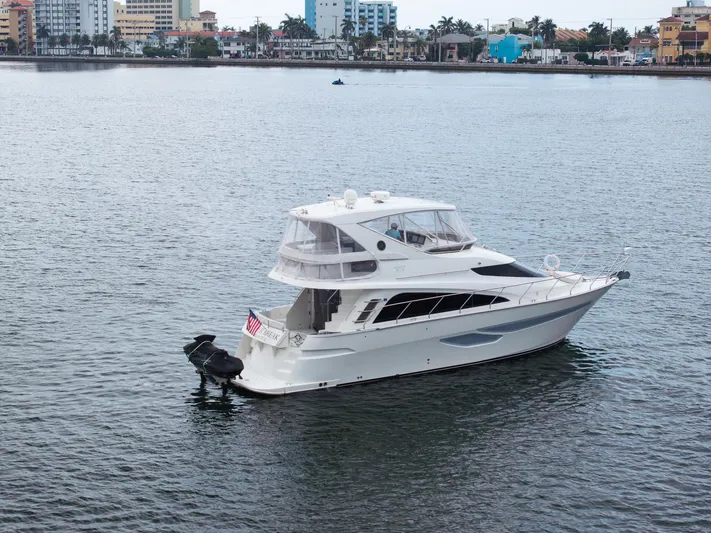 Water Break Yacht Photos Pics 2008 Marquis 50 LS yacht on calm water near city skyline.