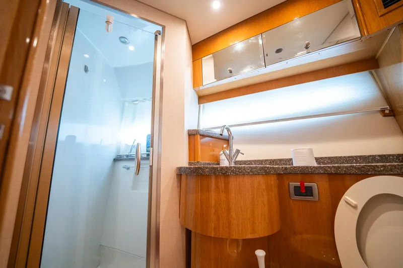 Water Break Yacht Photos Pics Luxurious bathroom in a 2008 Marquis 50 LS yacht with modern fixtures and elegant wood finishes.