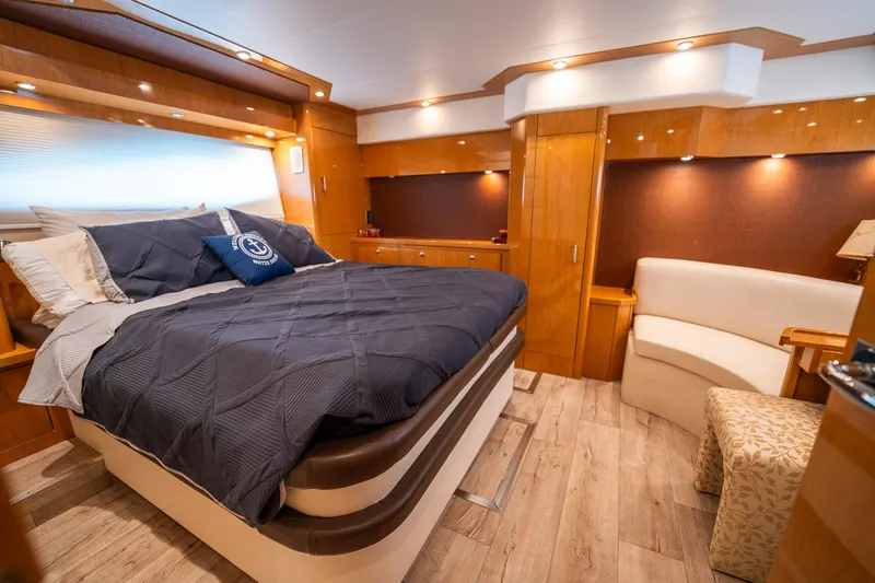 Water Break Yacht Photos Pics Luxurious 2008 Marquis 50 LS yacht bedroom with elegant wood finishes and cozy bedding.
