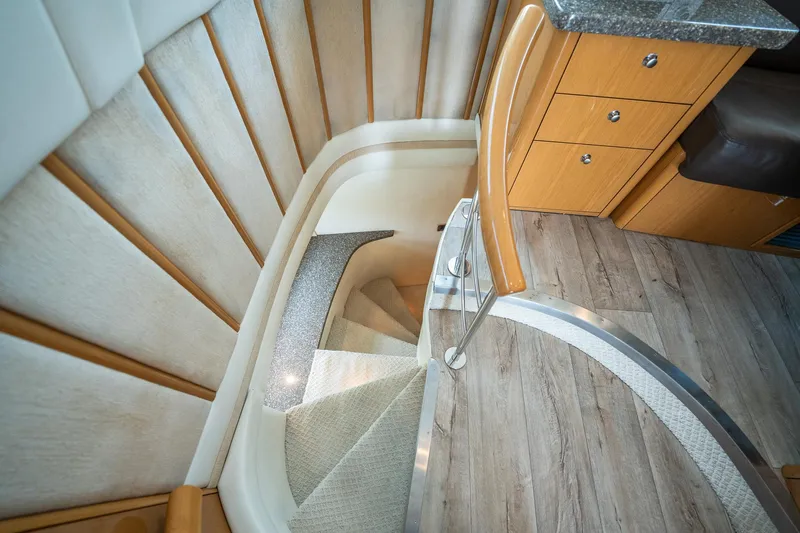 Water Break Yacht Photos Pics Interior staircase of 2008 Marquis 50 LS yacht with wooden and carpeted steps.