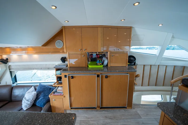 Water Break Yacht Photos Pics Luxurious interior of a 2008 Marquis 50 LS yacht with modern cabinetry and seating.