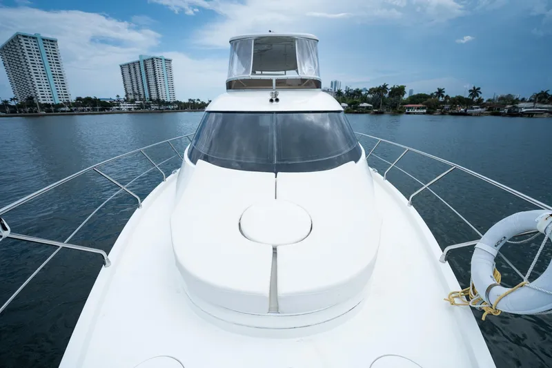 Water Break Yacht Photos Pics 2008 Marquis 50 LS yacht on water with city skyline in background.