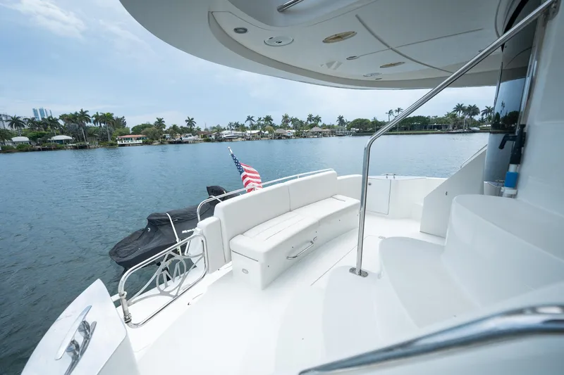 Water Break Yacht Photos Pics Luxury 2008 Marquis 50 LS yacht deck with seating, overlooking serene waterfront.