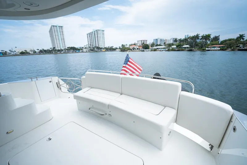 Water Break Yacht Photos Pics Luxurious 2008 Marquis 50 LS yacht with American flag, city skyline in background.