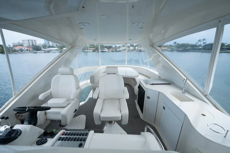 Water Break Yacht Photos Pics Luxurious interior of 2008 Marquis 50 LS yacht with white seating and control panel.