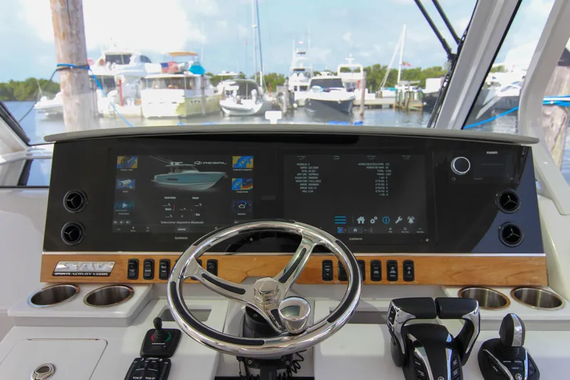  Yacht Photos Pics 2023 Regal 38 SAV helm with advanced navigation display and controls at marina.