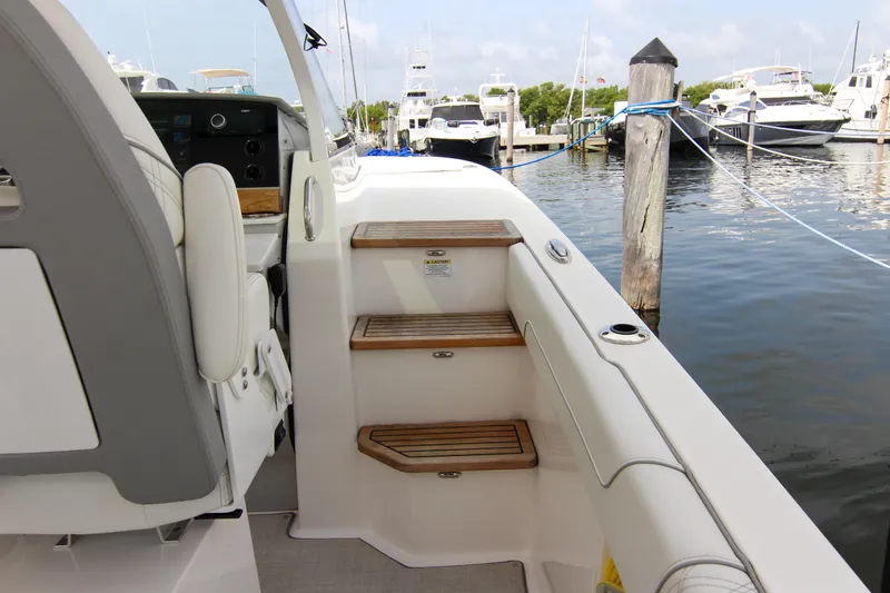  Yacht Photos Pics 2023 Regal 38 SAV boat interior with wooden steps at marina.