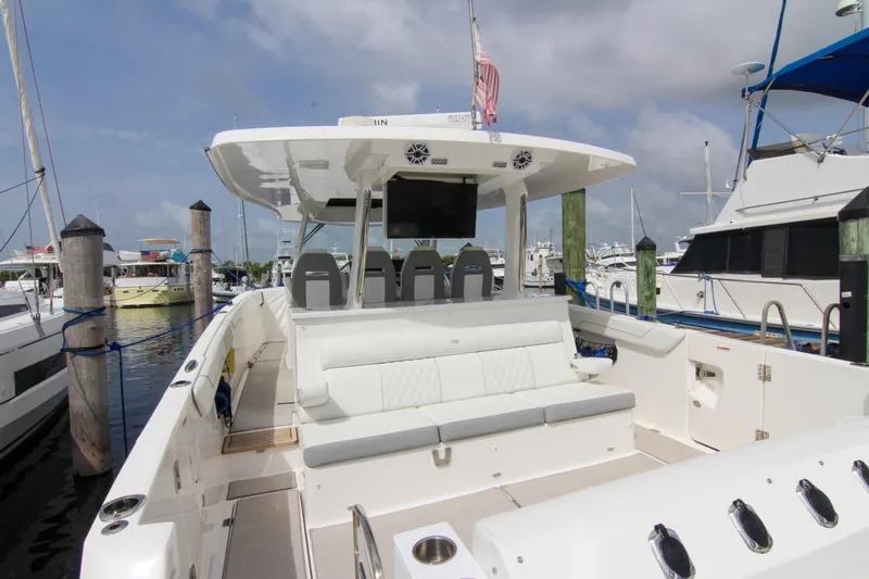  Yacht Photos Pics 2023 Regal 38 SAV luxury boat docked at marina, featuring spacious seating and modern design.