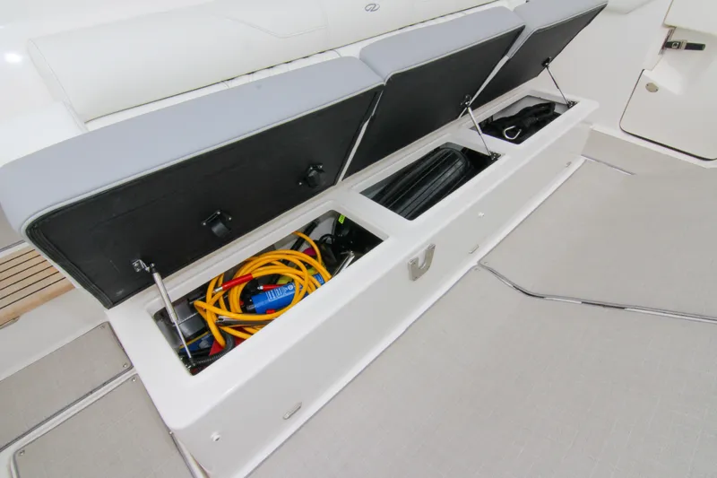  Yacht Photos Pics 2023 Regal 38 SAV boat storage compartment with open lids, revealing organized equipment.
