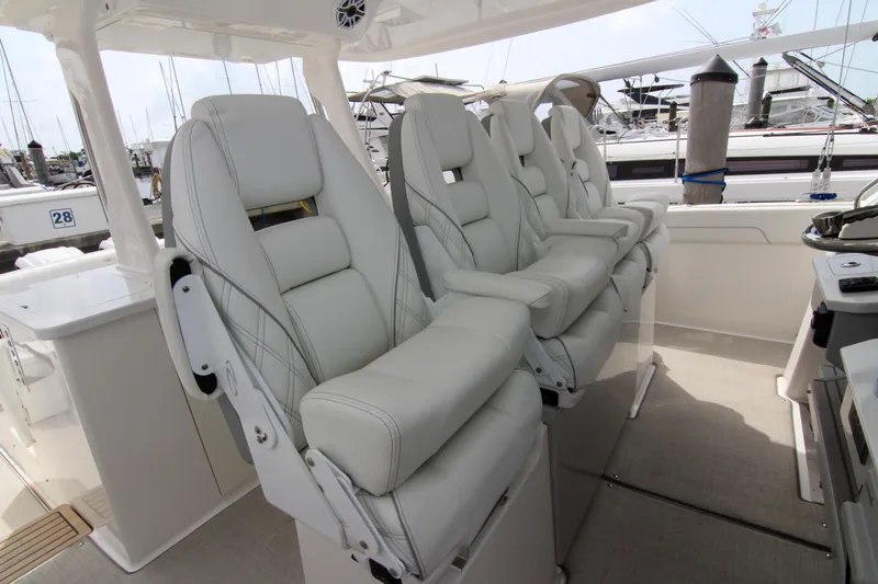  Yacht Photos Pics Luxurious seating on 2023 Regal 38 SAV boat, featuring plush white captain chairs.